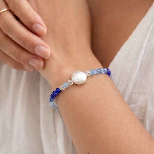 Pulsera azul con perla Océano artesanal hecha a mano en muñeca