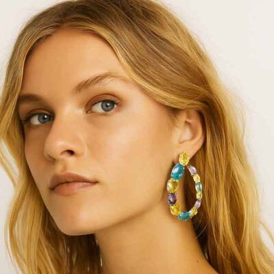 Modelo luciendo pendientes Iris multicolor en acabado plata