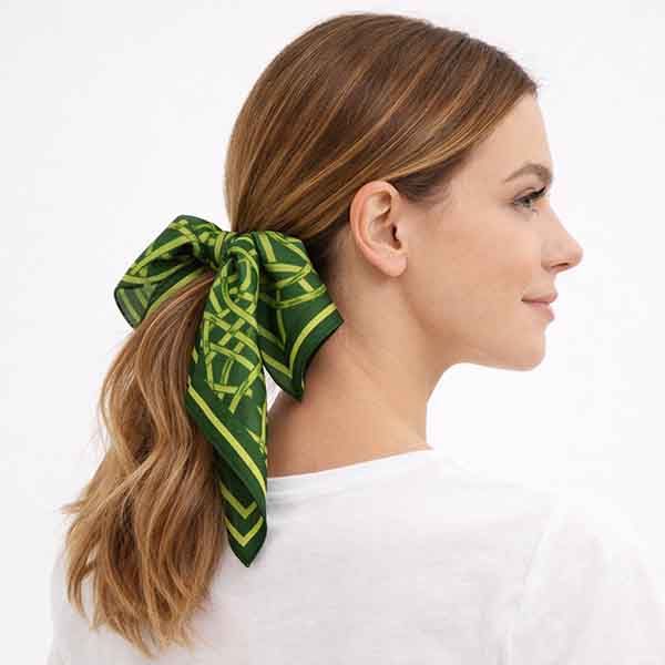 Pañuelo verde geométrico para el pelo atado en coleta