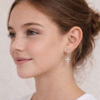 Pendientes de cruz en plata con circonitas blancas AMEN llevados por chica joven